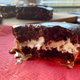 Closeup of a serving of Jos Louis cake with a bite taken out to show cross-section